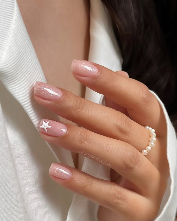 soft pink neutral nails with white stars